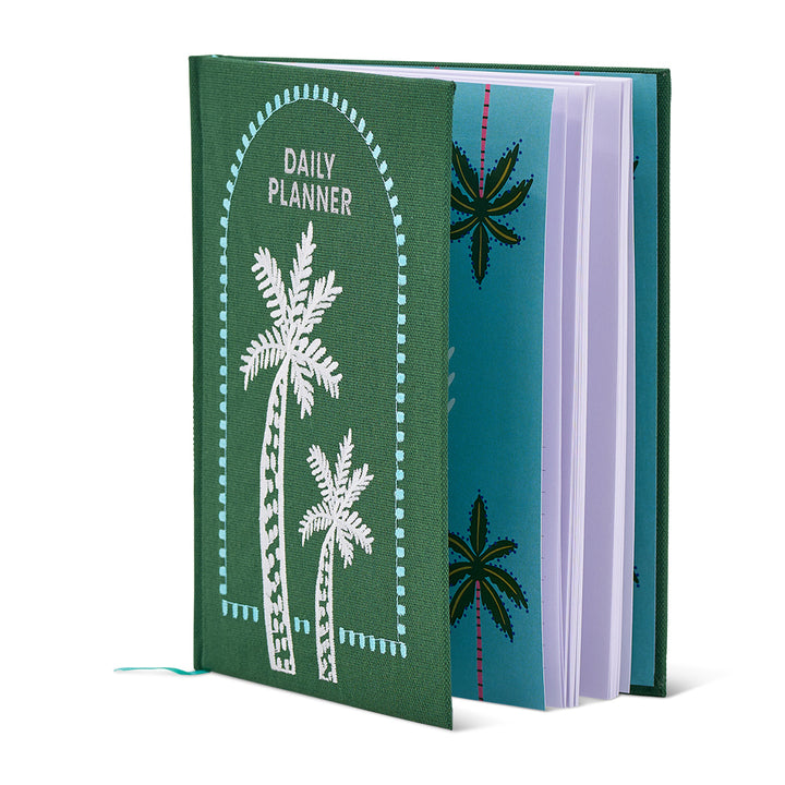 Green planner with palm tree designs on a white background