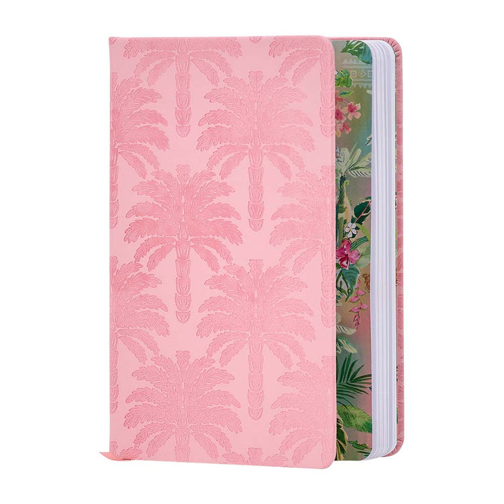 Notebook with pink palm leaf pattern on one side and floral design on the other, on a white background.