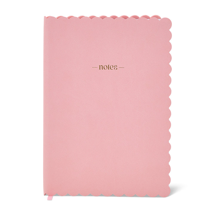 Pink notebook with scalloped edge and 'notes' text on a white background