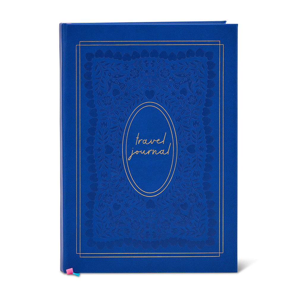 Blue travel journal with decorative cover on a white background