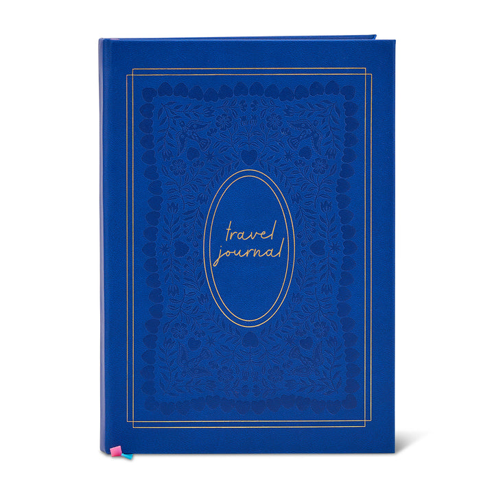 Blue travel journal with decorative cover on a white background