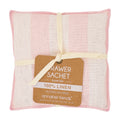 Pink and white linen drawer sachet with a label on a white background