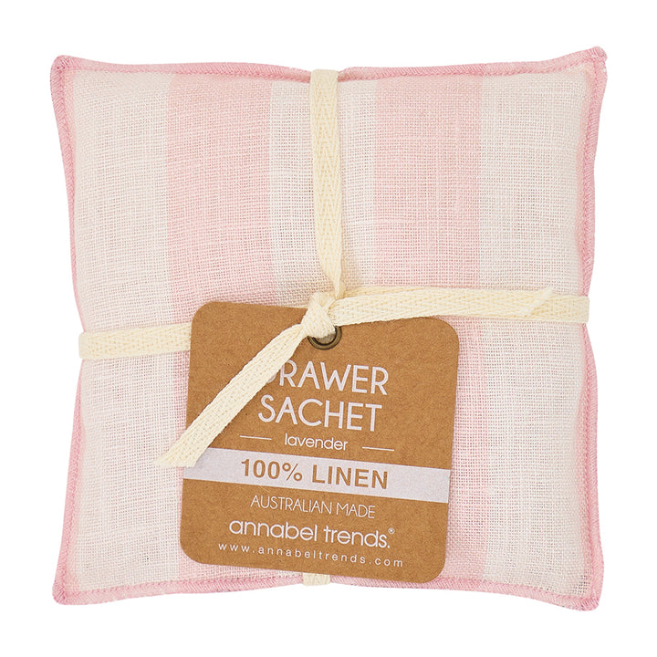 Pink and white linen drawer sachet with a label on a white background