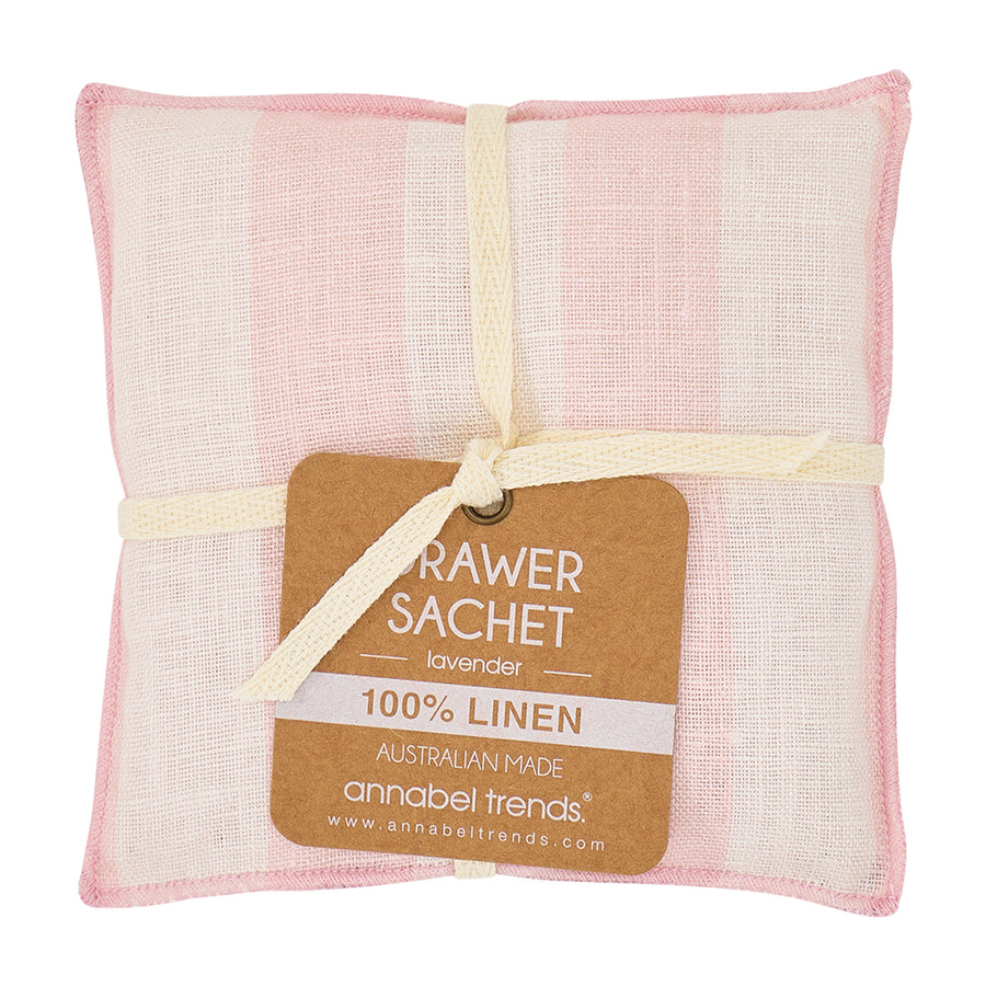 Pink and white linen drawer sachet with a label on a white background