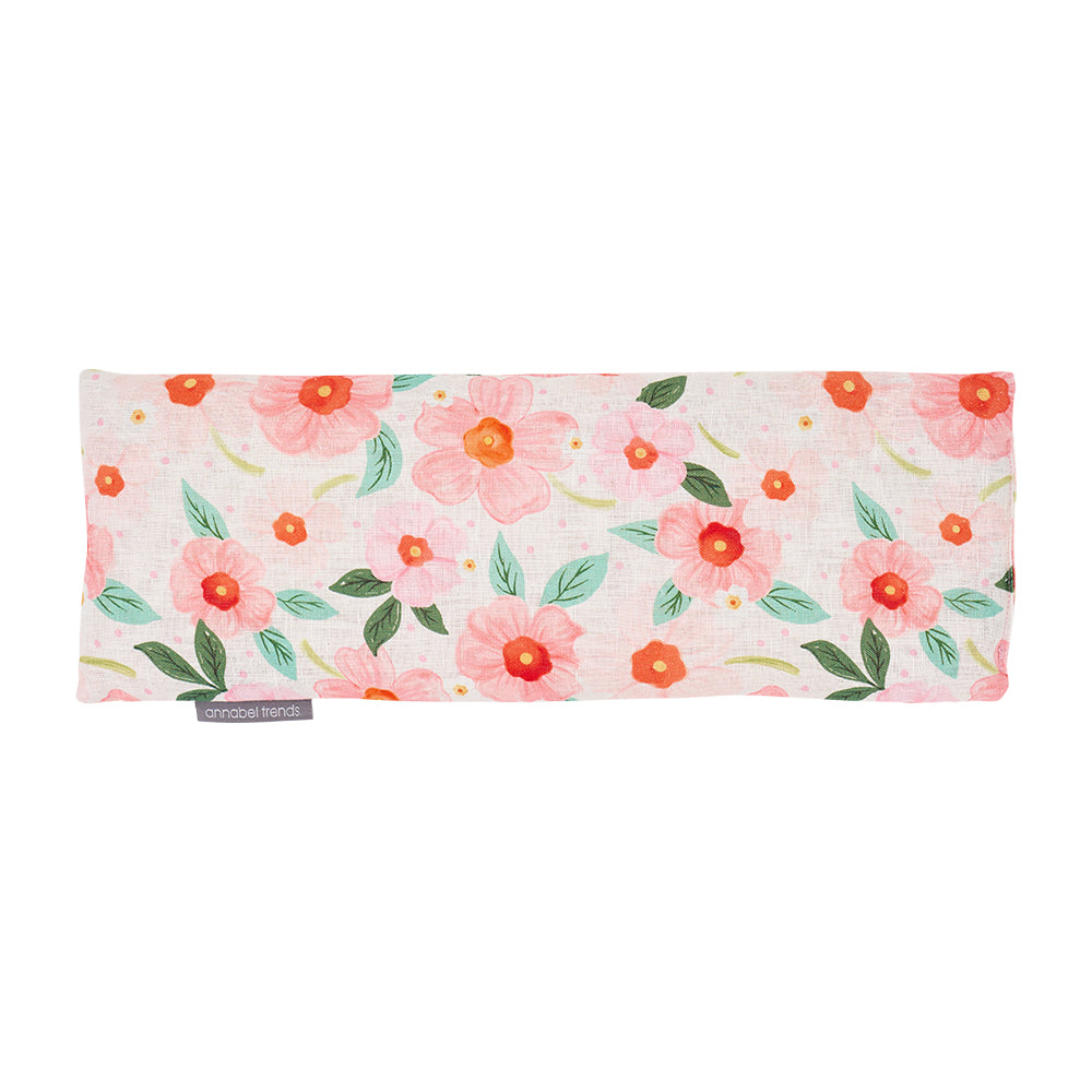 Floral patterned linen heat pillow on a white background