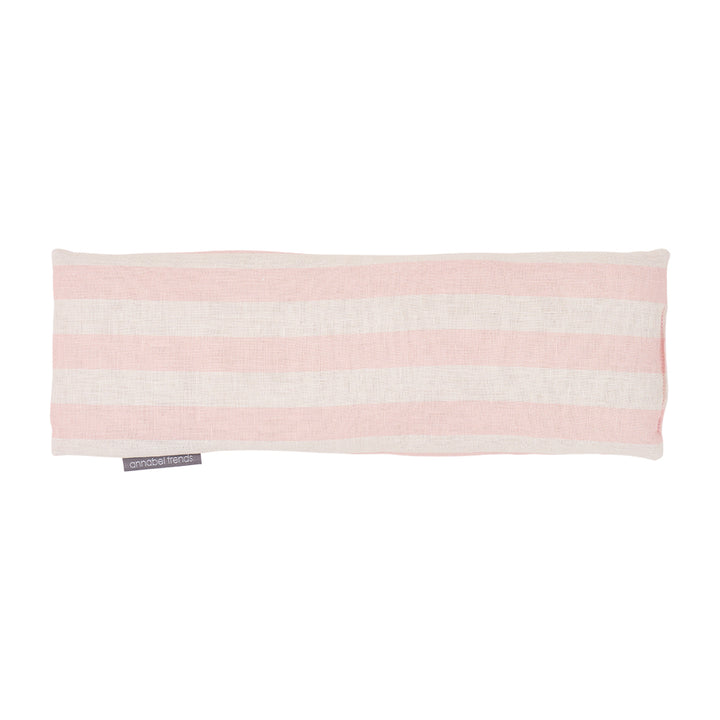 Pink and white striped linen heat pillow on a white background