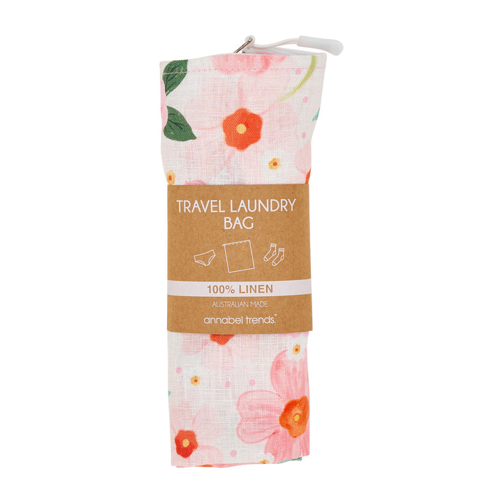 Floral travel laundry bag with brown label on a white background