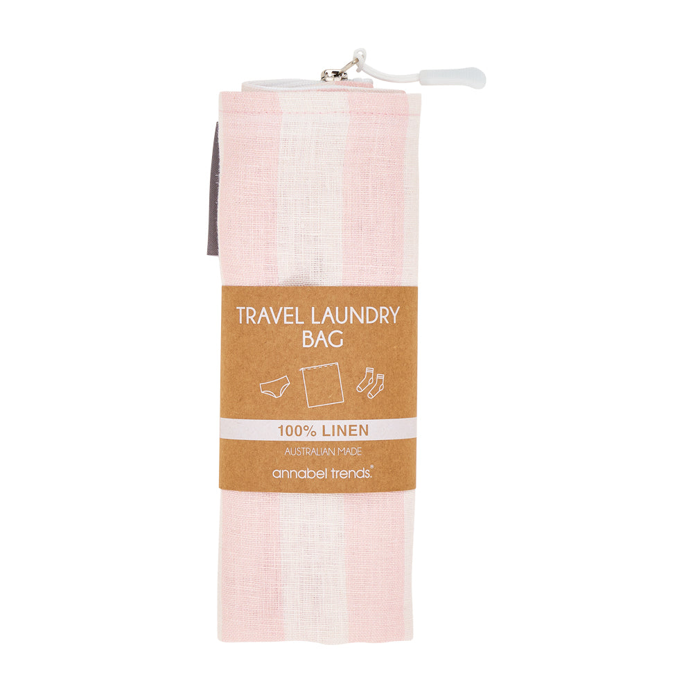 Pink travel laundry bag with a brown label on a white background