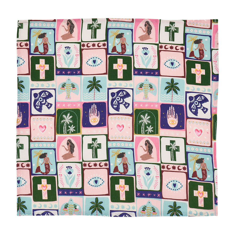 Patterned celestial dreams linen napkin with various symbols and designs on a white background