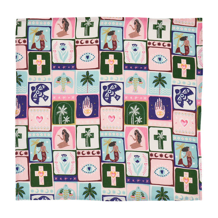 Patterned celestial dreams linen napkin with various symbols and designs on a white background