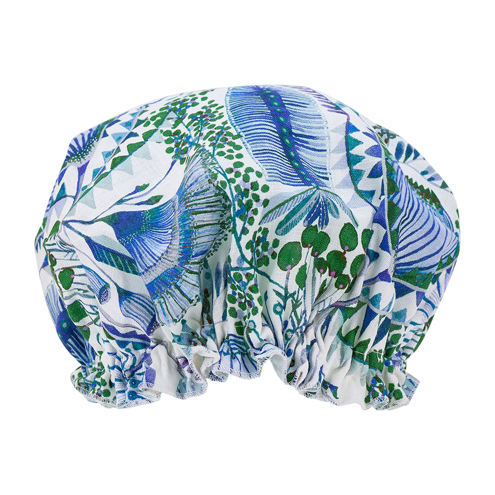 Bush botanical Patterned shower cap with blue and green design on a white background