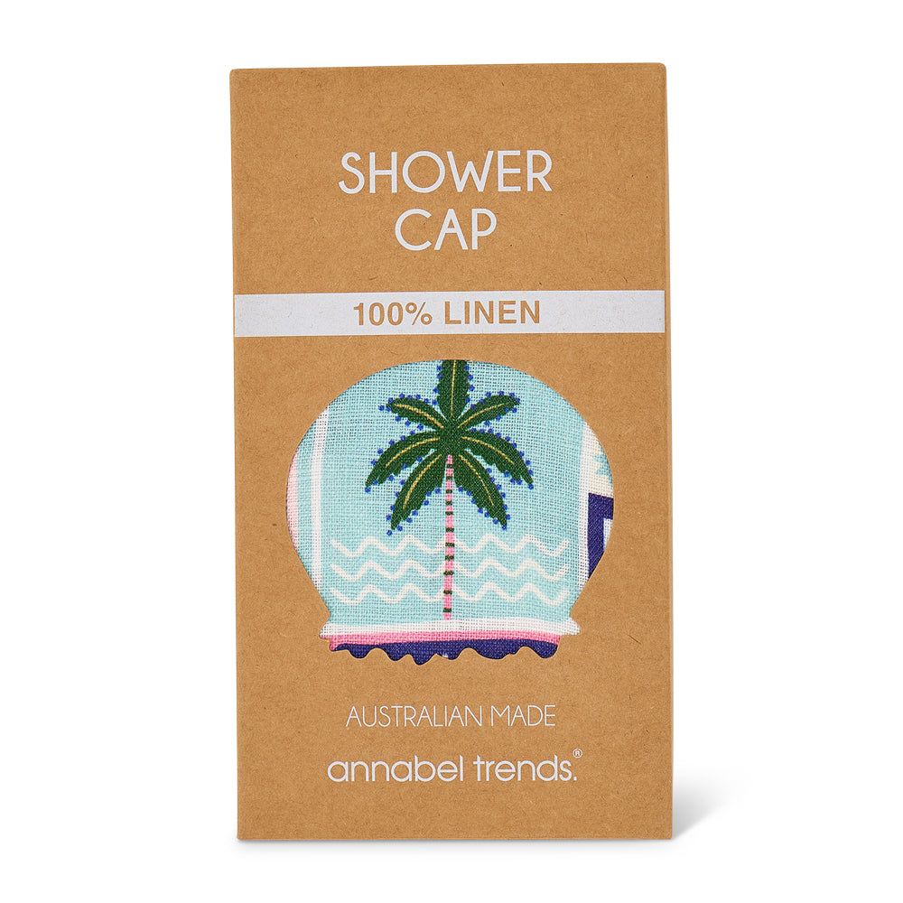 Brown packaging of celestial dreams shower cap with a palm tree design, labeled '100% linen' and 'Australian made' by Annabel Trends.