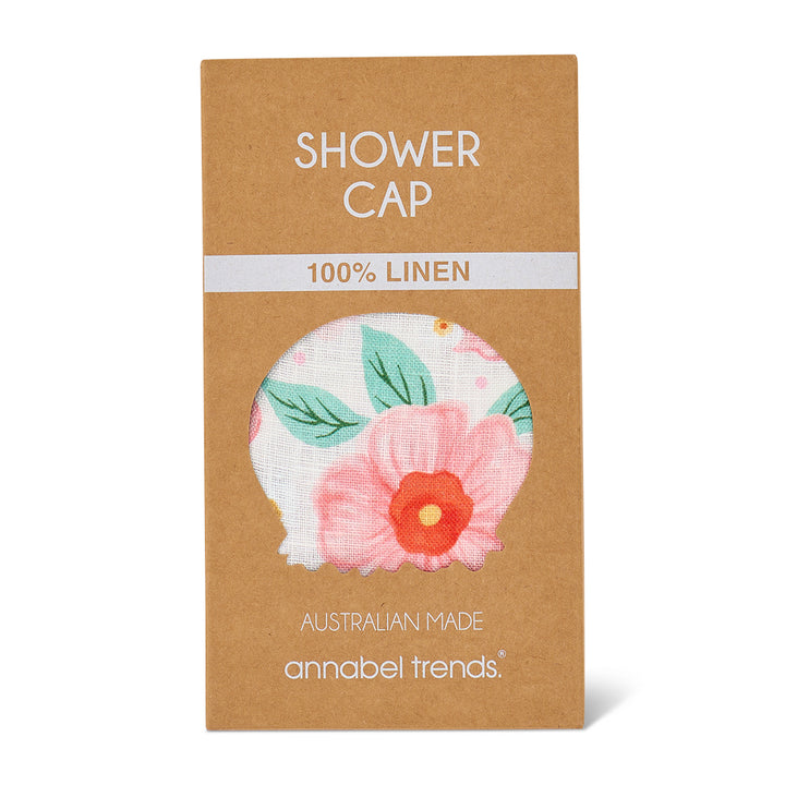 Shower cap packaging with floral design on a brown background