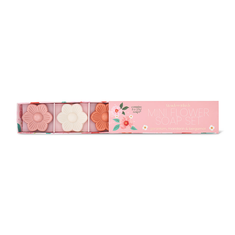 Set of floral-themed soap bars in a pink box with decorative elements on a white background