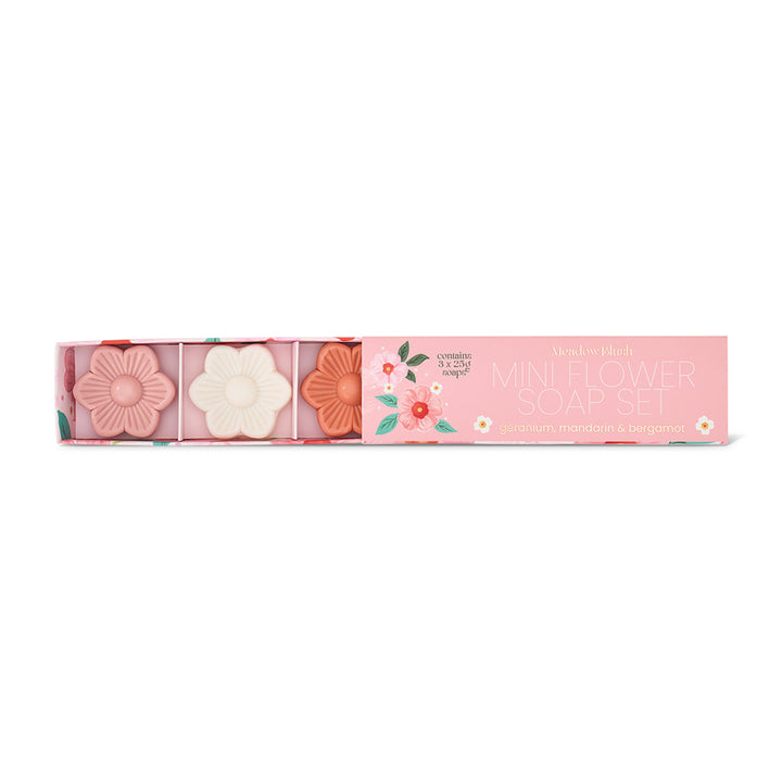 Set of floral-themed soap bars in a pink box with decorative elements on a white background
