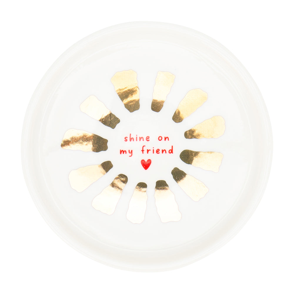Decorative plate with gold accents and 'shine on my friend' text on a white background