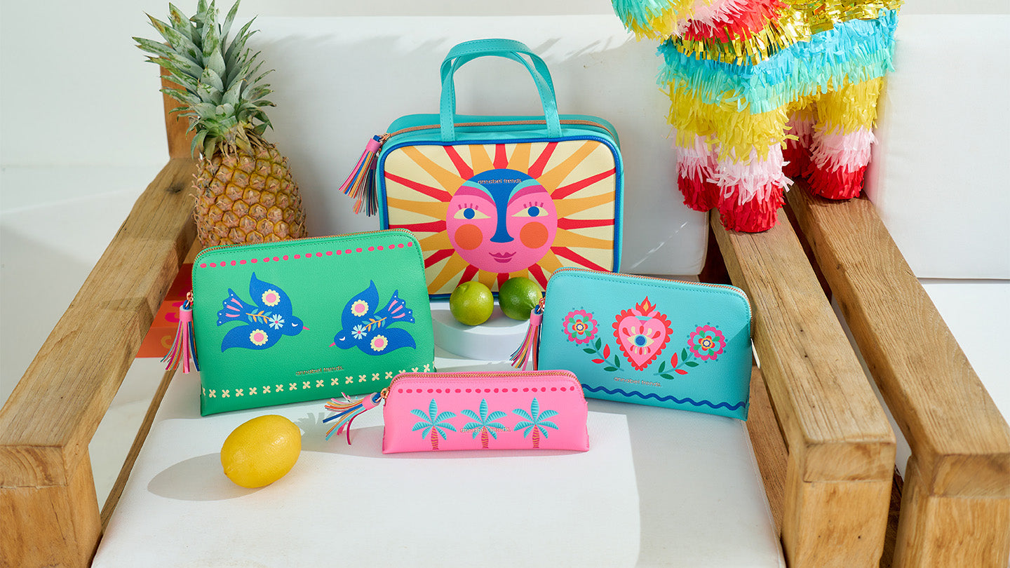 Colourful Vanity toiletry bags on a wooden chair in the Annabel Trends Fiesta Design
