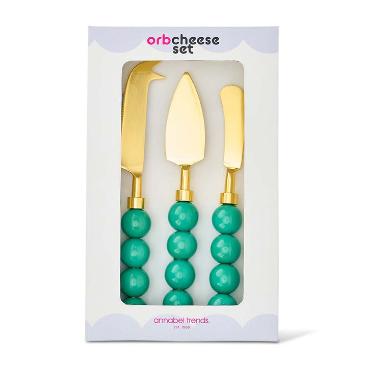 Gold cheese knives with turquoise beads in packaging, brand 'annabel Trends' visible