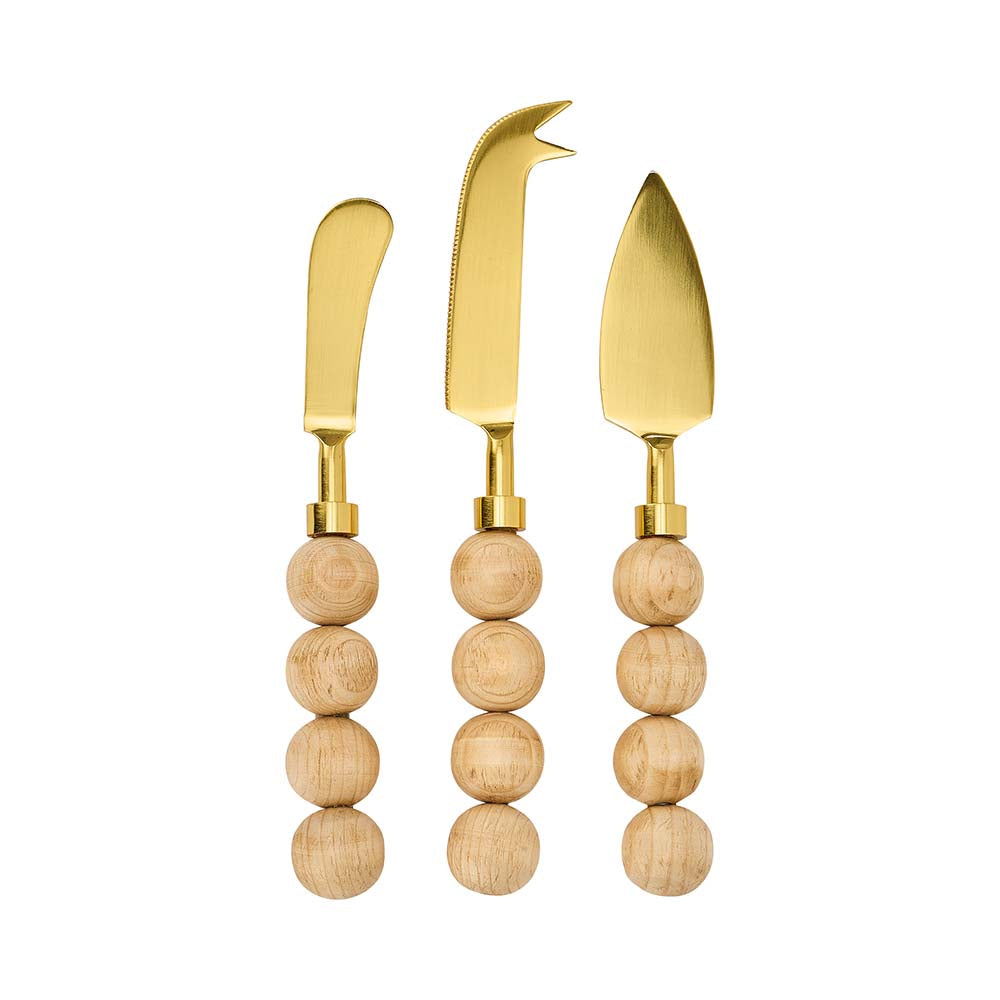 Set of three gold cheese knives with wooden handles on a white background