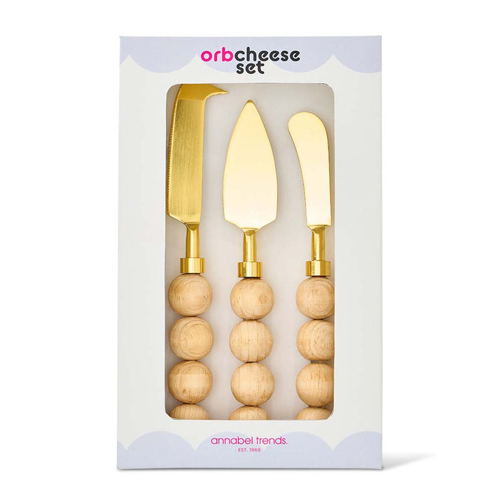 Set of three cheese knives with wooden handles and gold accents in packaging, brand 'annabel Trends' visible.