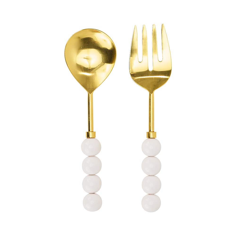 Gold spoon and fork with white bead handles on a white background