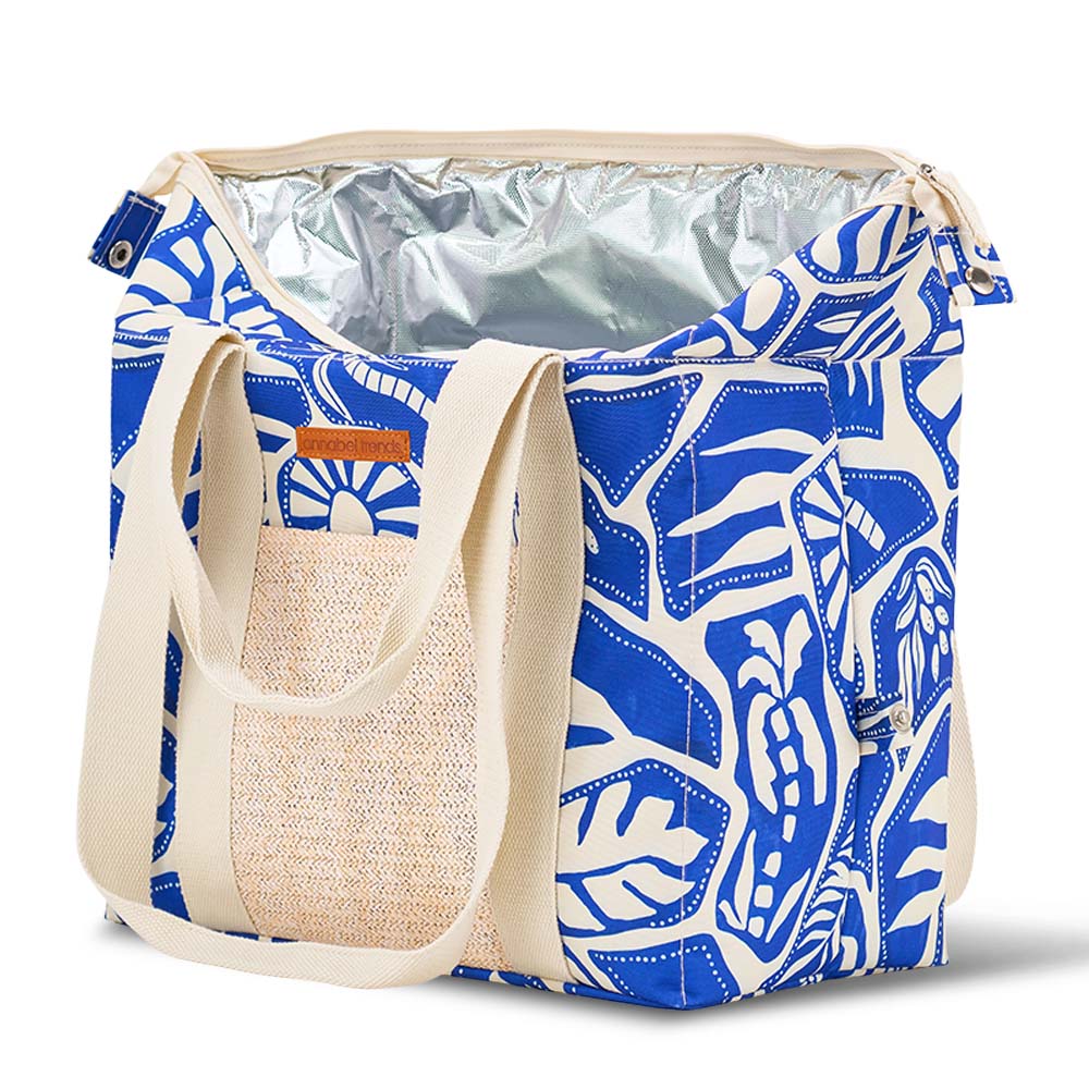 Blue and white patterned cooler bag with beige handle and pocket on a white background
