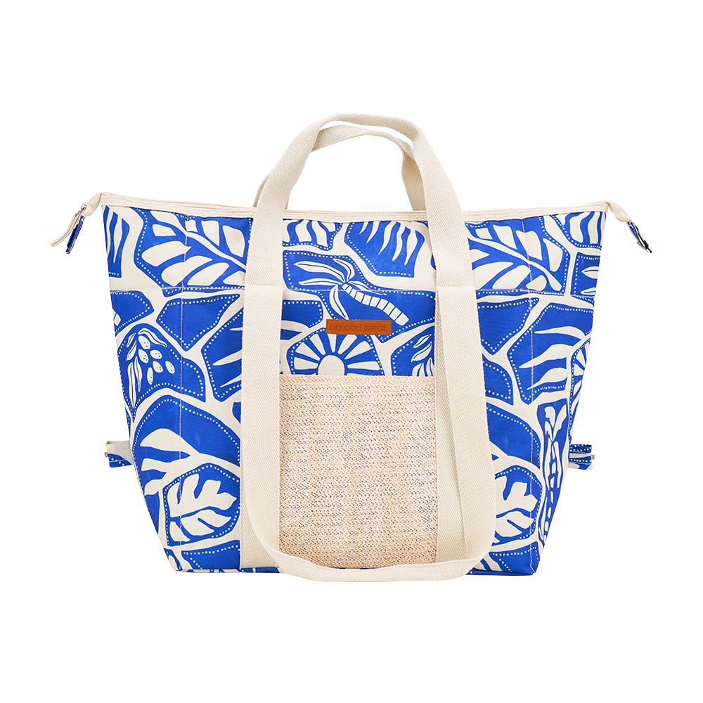 Blue and white patterned tote bag with a woven pocket on a white background