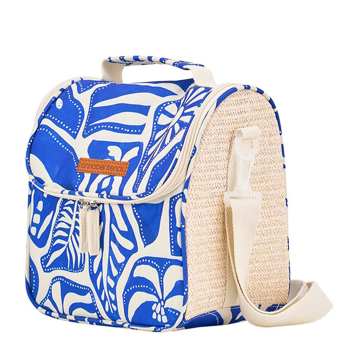 Blue and white patterned bag with a beige strap on a white background