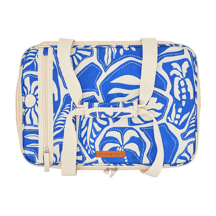 Blue and white patterned bag with straps on a white background