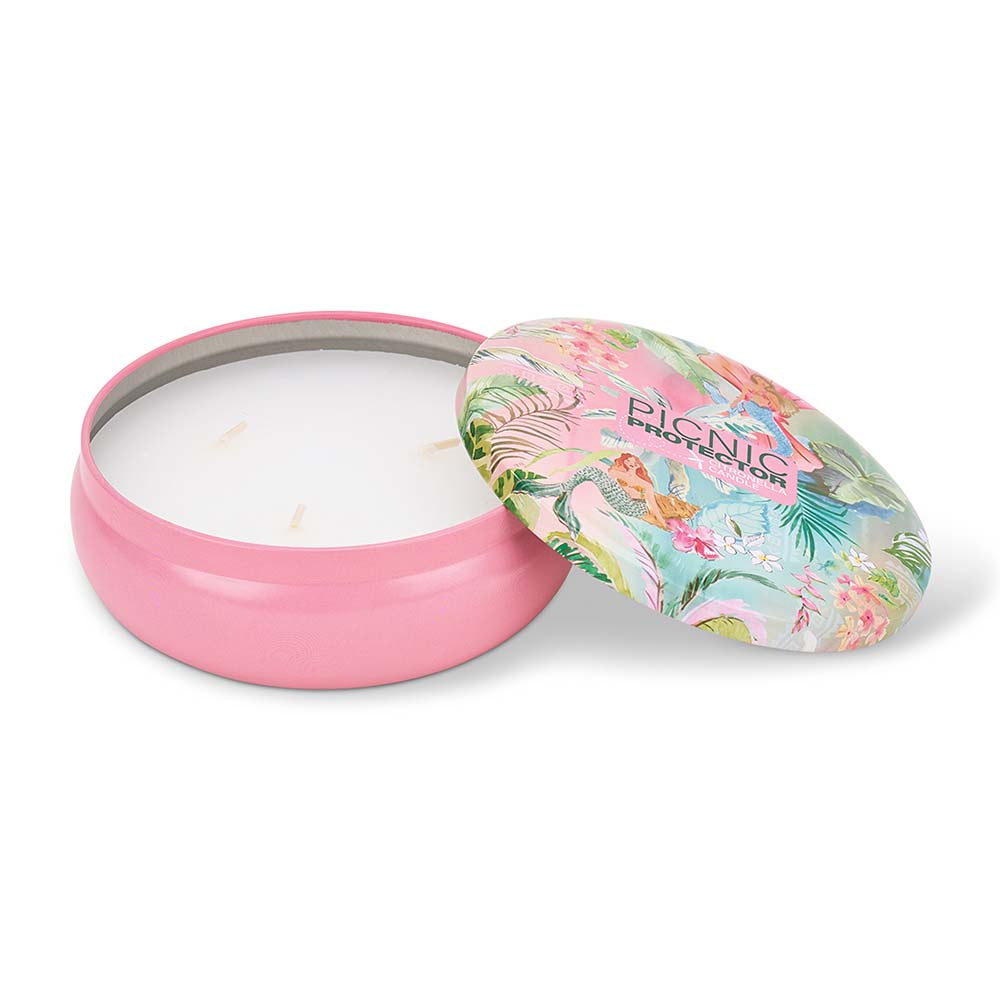 Candle in a pink tin with a floral lid on a white background