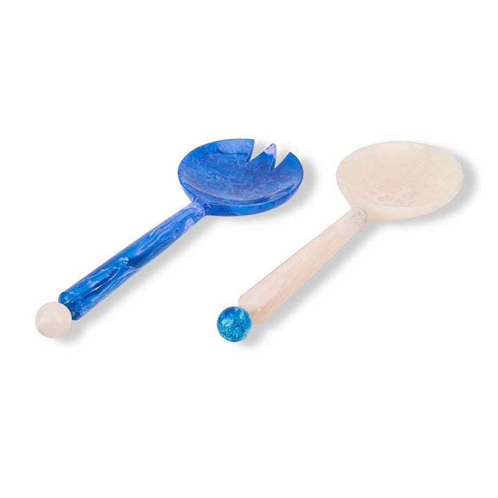 Two wooden spoons with blue accents on a white background