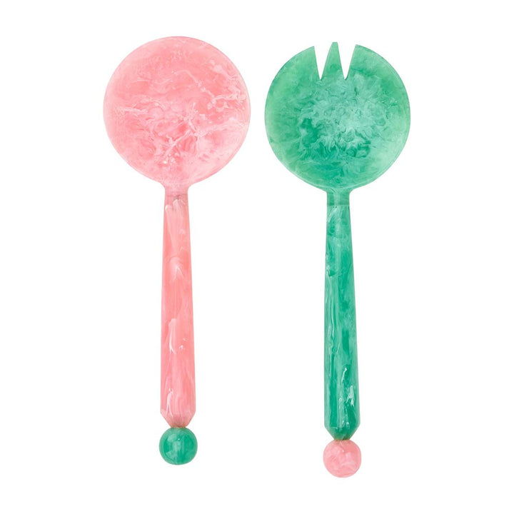Pink and green marbled salad servers on a white background