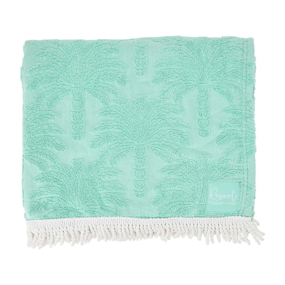 Turquoise towel with white fringe on a white background