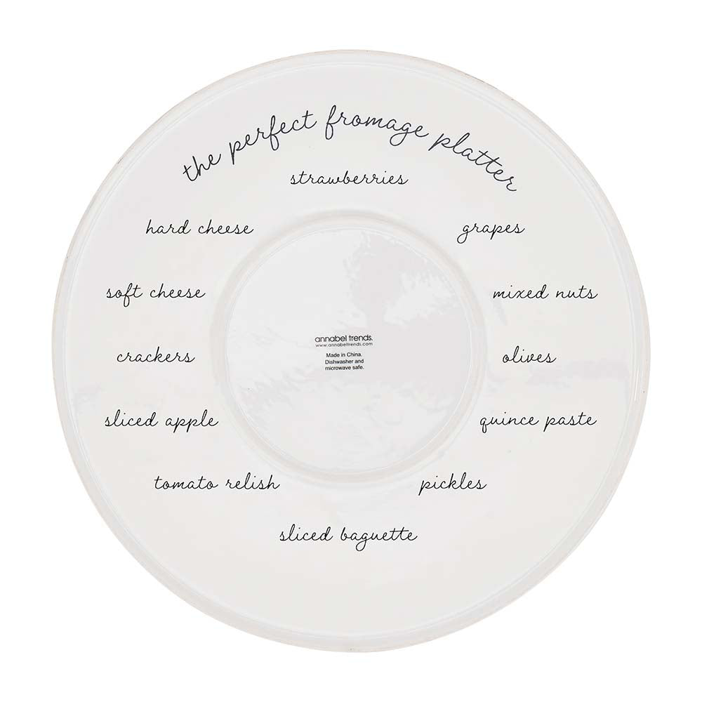 White ceramic platter with text labels for a fromage platter on a white background