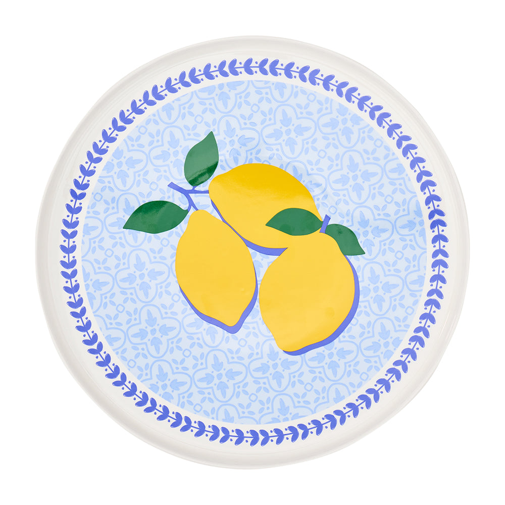 ceramic serving plate for cakes with blue background and three lemons in the centre