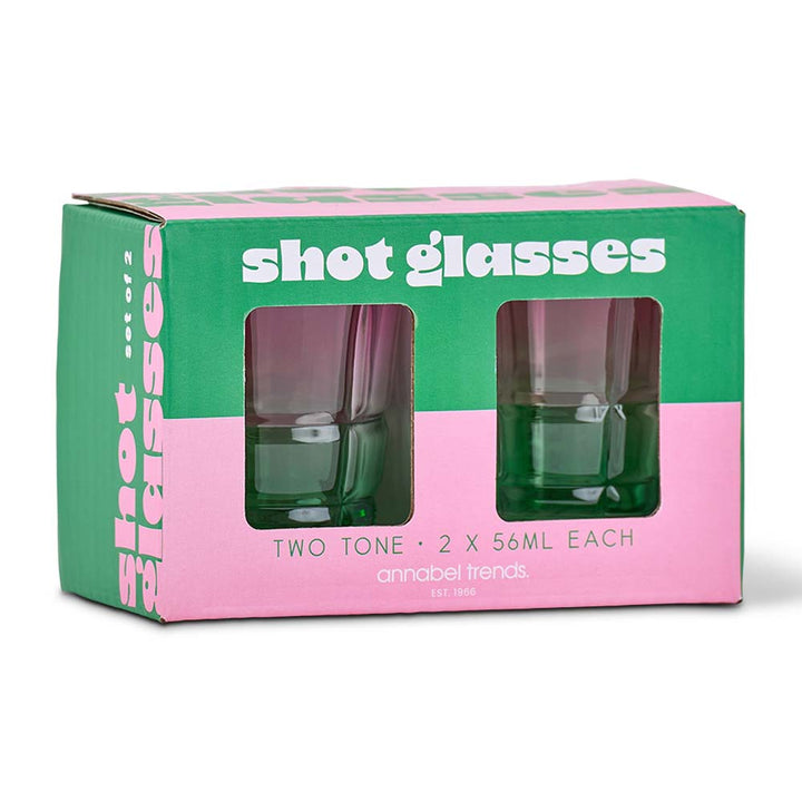 Packaging of two green shot glasses with a pink and green box.