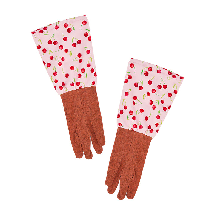 Pair of gardening gloves with cherry pattern on a pink background