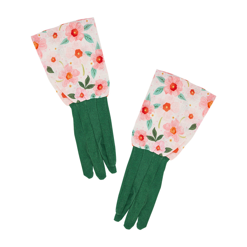 Pair of green and meadow blush gardening gloves with floral cuffs on a white background