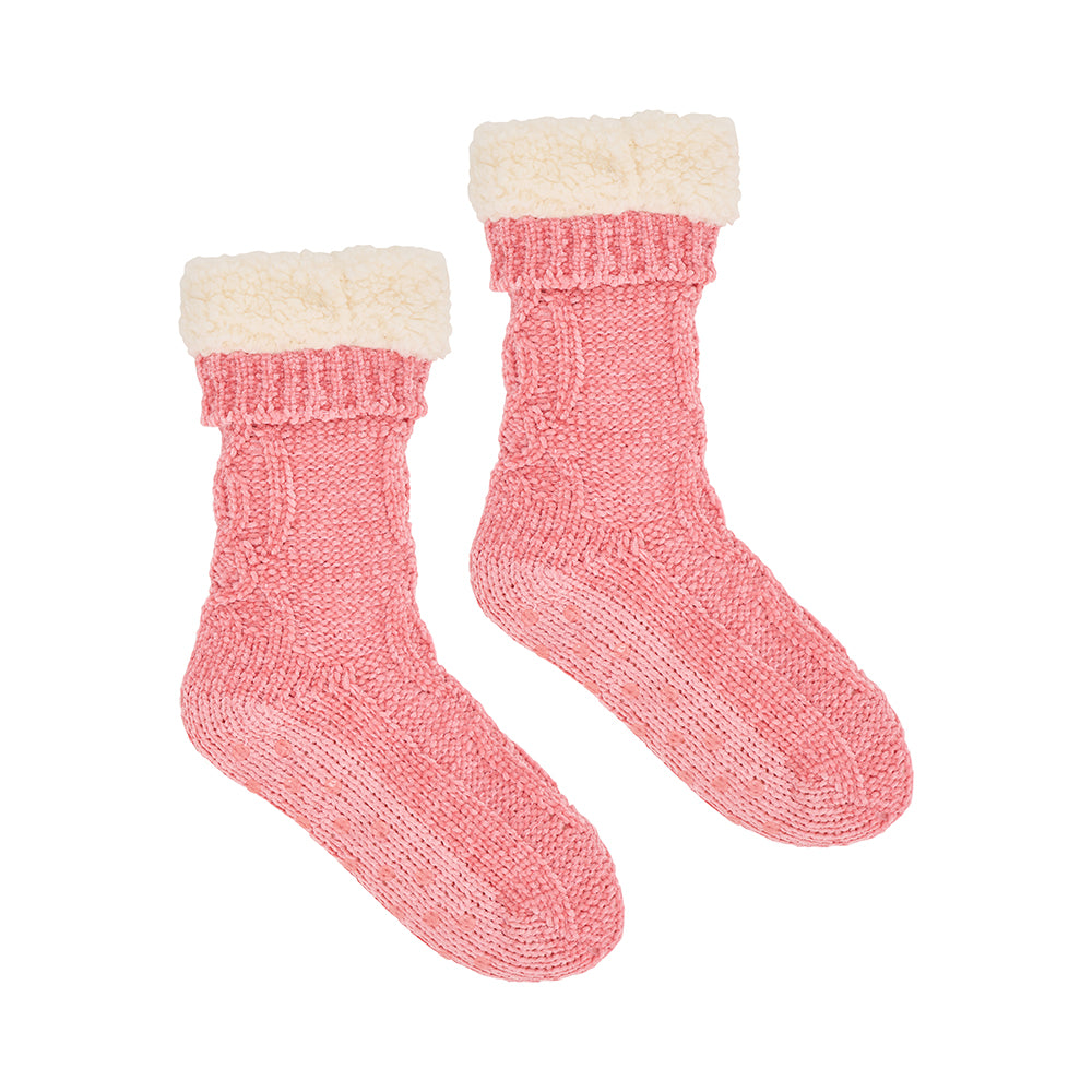 Pair of pink knitted sherpa lined socks on a white background