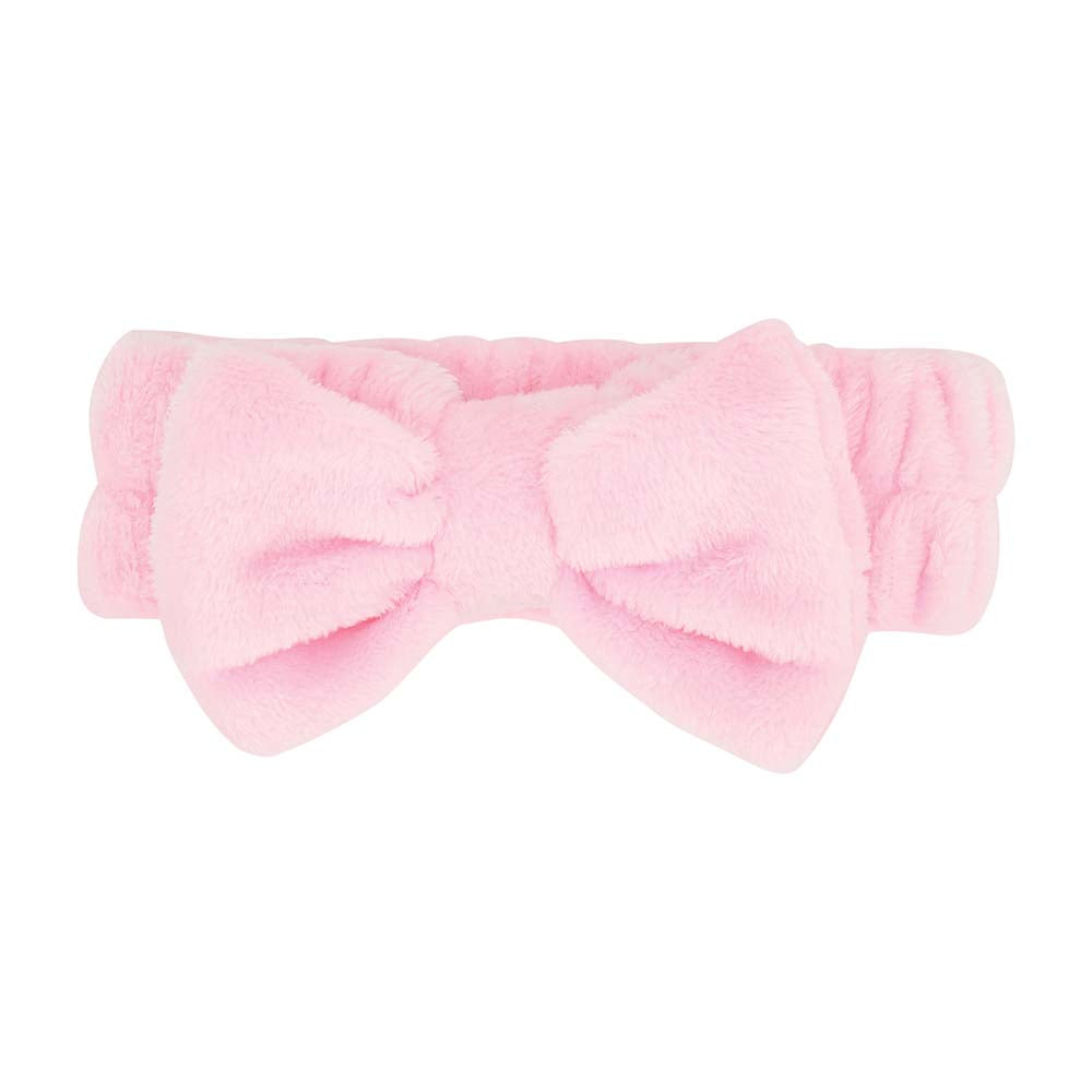 Pink headband with a large bow on a white background