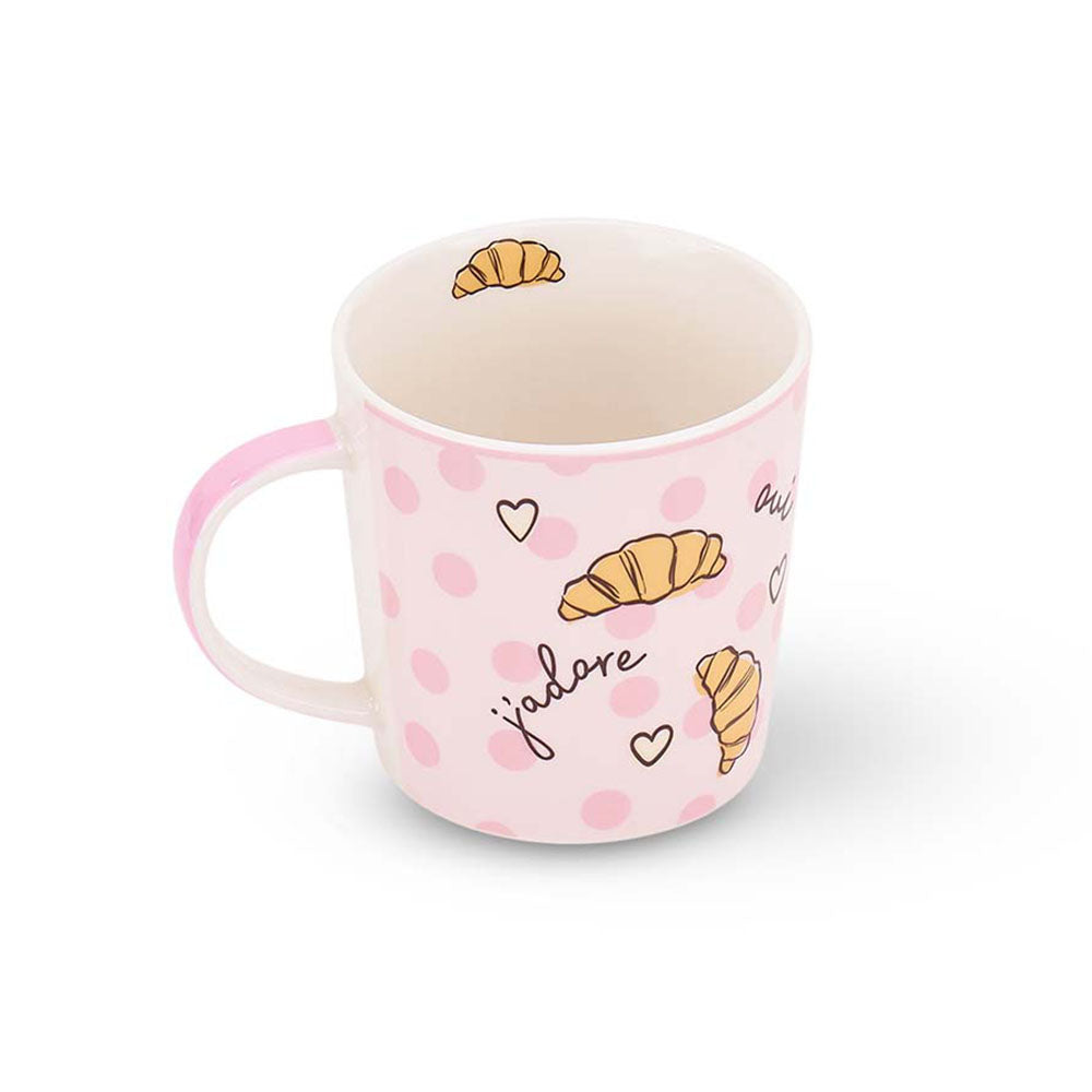 Pink mug with croissant and polka dot design on a white background