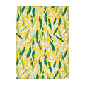 Patterned tea towel with yellow flowers and green leaves on a white background