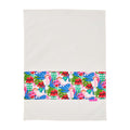 Colorful tropical patterned tea towel on a white background