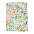 Tropical-themed tea towel with mermaids and floral patterns on a white background
