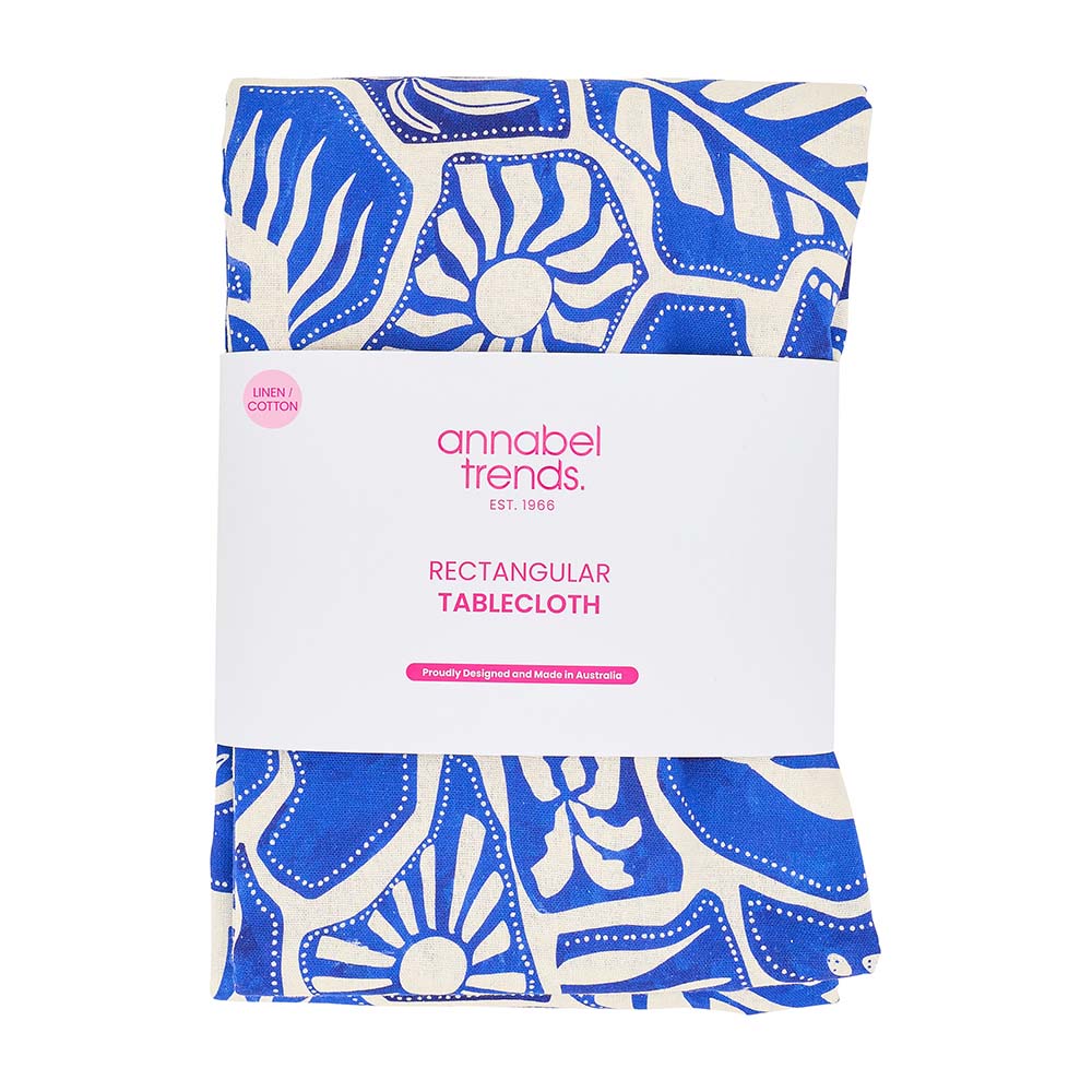 Packaged rectangular tablecloth with blue and white pattern on a white background