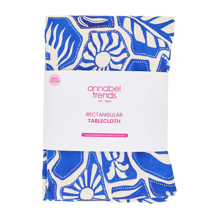 Packaged rectangular tablecloth with blue and white pattern on a white background