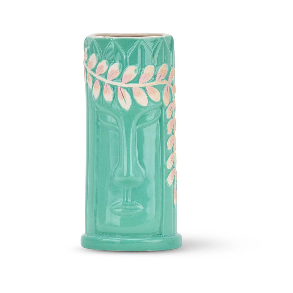 Turquoise tiki mug with pink leaf design on a white background