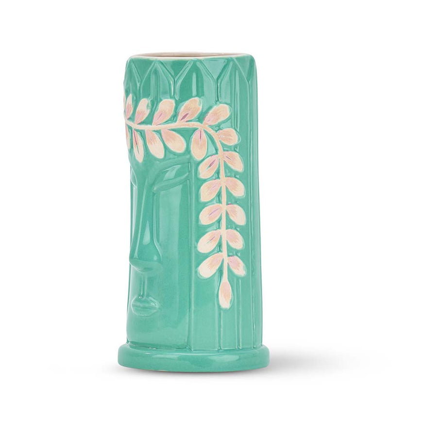 Turquoise tiki mug with leaf design on a white background