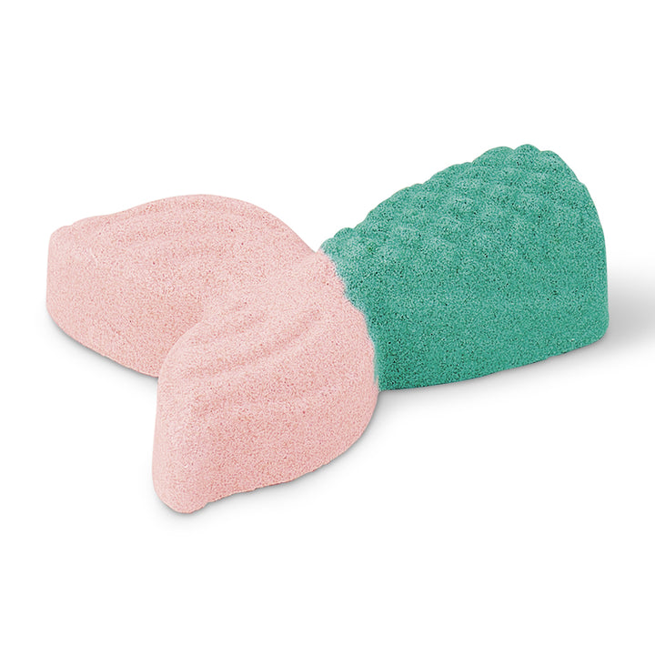 Pink and green mermaid shaped bath fizzer on a white background