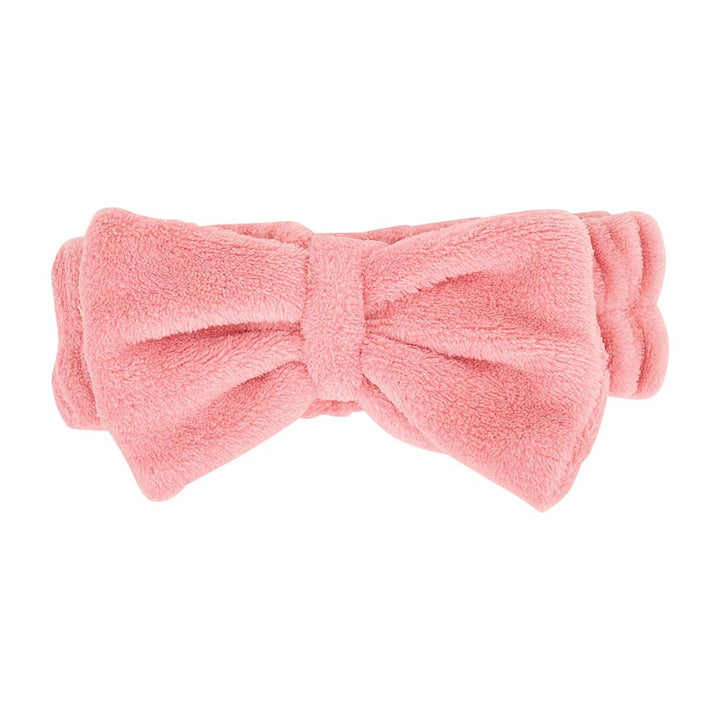 Pink bow-shaped headband on a white background